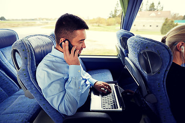 Image showing man with smartphone and laptop in travel bus