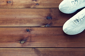 Image showing close up of sneakers on wooden floor