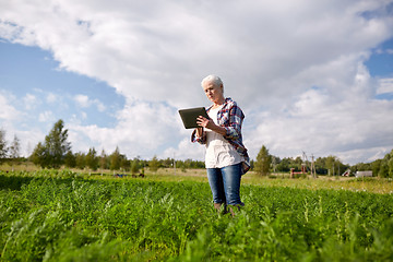 Image showing senior woman with tablet pc computer at county