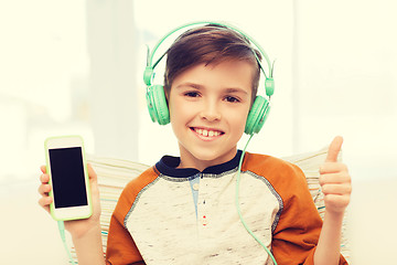 Image showing happy boy with smartphone and headphones at home