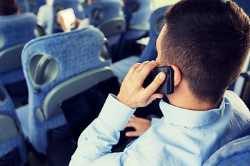 Image showing man with smartphone and laptop in travel bus