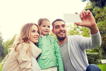 Image showing happy family taking selfie by smartphone outdoors