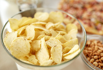 Image showing close up of crunchy potato crisps in glass bowl