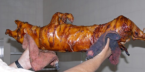 Image showing Preparation of roasted pork, a traditional Portuguese recipe, Lisbon, Portugal