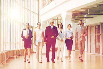 Image showing business people walking along office building