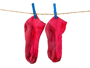 Image showing Pair of washed red socks on rope