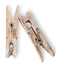 Image showing Two old wooden clothespins beside