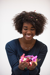 Image showing African American woman blowing confetti in the air