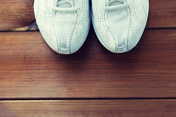 Image showing close up of sneakers on wooden floor