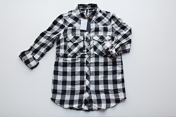 Image showing checkered shirt with price tag on white background