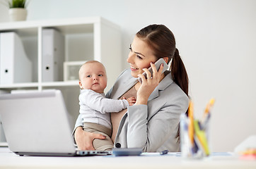 Image showing businesswoman with baby and smartphone at office