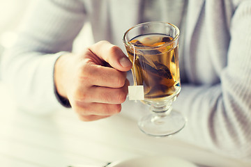 Image showing close up of man drinking tea at home or cafe
