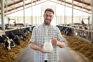 Image showing man or farmer with cows milk on dairy farm