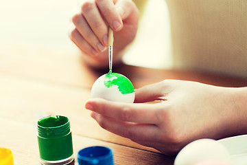 Image showing close up of woman hands coloring easter eggs