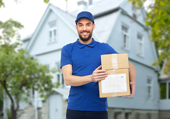 Image showing happy delivery man with parcel boxes