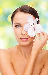 Image showing beautiful young woman with orchid flower