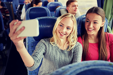 Image showing women taking selfie by smartphone in travel bus