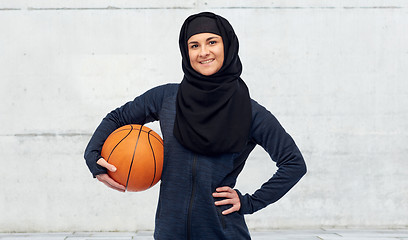 Image showing happy muslim woman in hijab with basketball