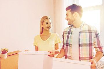 Image showing smiling couple with big boxes moving to new home