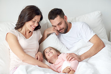 Image showing happy family in bed at home