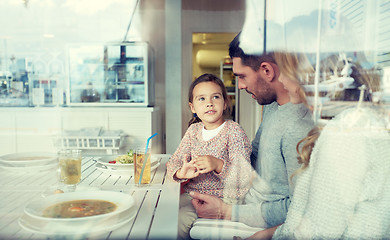 Image showing happy family having dinner at restaurant or cafe