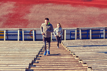 Image showing happy couple running upstairs on stadium