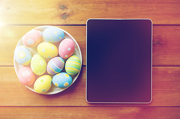 Image showing close up of easter eggs and blank tablet pc