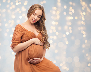 Image showing happy pregnant woman touching her big belly