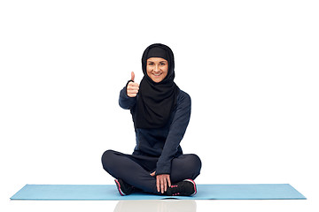 Image showing muslim woman doing sport and showing thumbs up