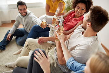 Image showing happy friends drinking beer at home party