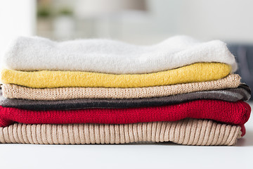 Image showing close up of stacked knitted clothes