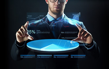 Image showing close up of businessman with virtual charts