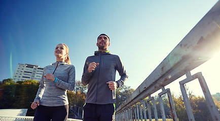 Image showing happy couple running outdoors