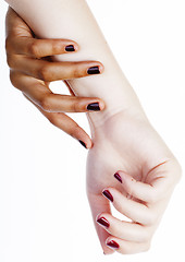 Image showing two different nathion manicured hands on white isolated, african