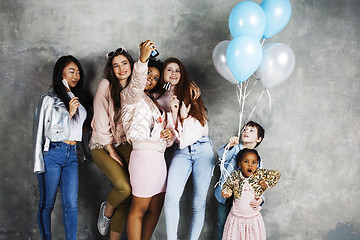 Image showing Lifestyle and people concept: young pretty diversity nations woman with different age children celebrating on birth day party together happy smiling, making selfie. African-american, asian and caucasi