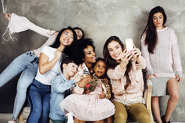 Image showing Lifestyle and people concept: young pretty diversity nations woman with different age children celebrating on birth day party together happy smiling, making selfie. African-american, asian and caucasi