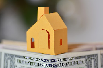 Image showing Miniature paper made house stand on  money