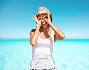 Image showing happy young woman in hat over blue sky and sea