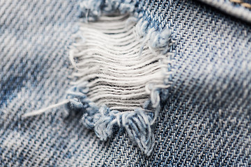 Image showing close up of hole on shabby denim or jeans clothes