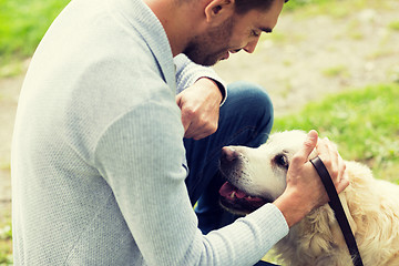 Image showing close up of man with labrador dog outdoors