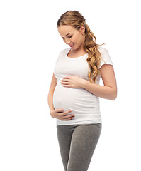 Image showing happy pregnant woman touching her big belly