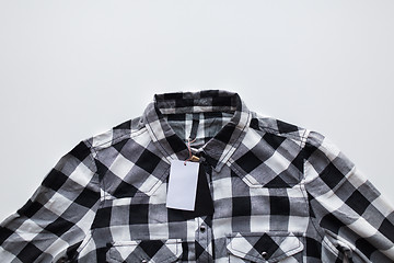 Image showing close up of checkered shirt on white background