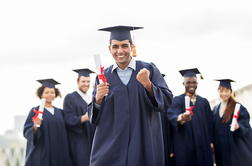 Image showing happy student with diploma celebrating graduation