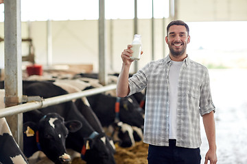 Image showing man or farmer with cows milk on dairy farm