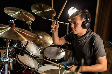 Image showing male musician playing drums and cymbals at concert