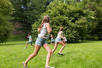 Image showing group of happy kids or friends playing outdoors