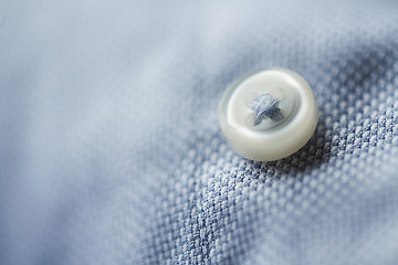 Image showing close up of blue shirt button