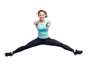 Image showing happy smiling sporty young woman jumping in air