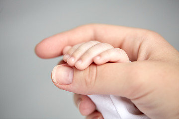 Image showing close up of mother and newborn baby hands