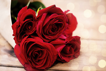 Image showing close up of red roses bunch wrapped into paper